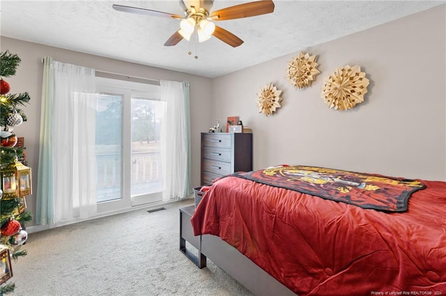 carpeted bedroom featuring ceiling fan, a textured ceiling, and access to outside