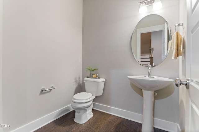 bathroom with toilet and wood-type flooring