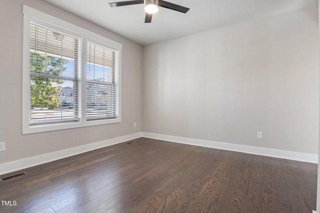 spare room with ceiling fan and dark hardwood / wood-style flooring