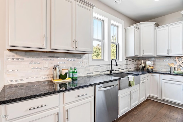 kitchen with dishwasher, sink, dark stone counters, white cabinets, and dark wood-type flooring