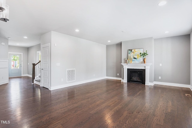 unfurnished living room with dark hardwood / wood-style floors