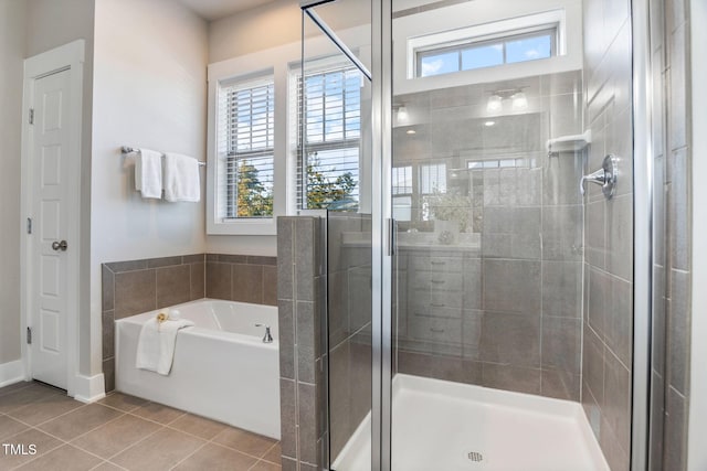 bathroom with independent shower and bath and tile patterned floors