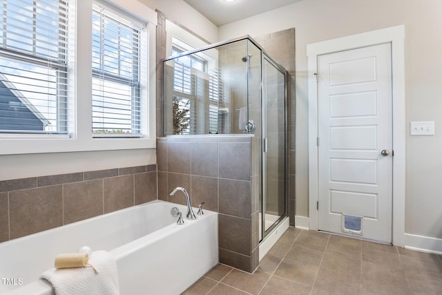 bathroom with independent shower and bath and tile patterned floors