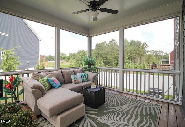 sunroom featuring ceiling fan