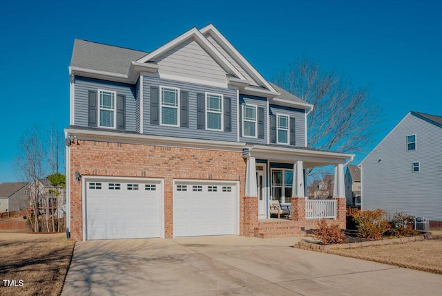 craftsman house featuring a garage, central air condition unit, and covered porch