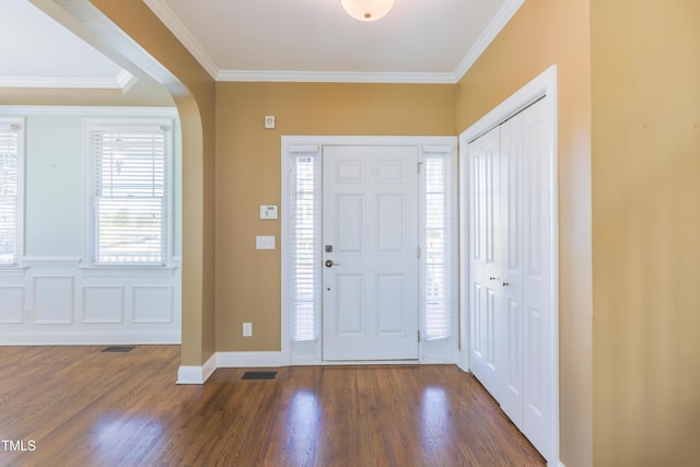 foyer featuring dark hardwood / wood-style flooring and ornamental molding