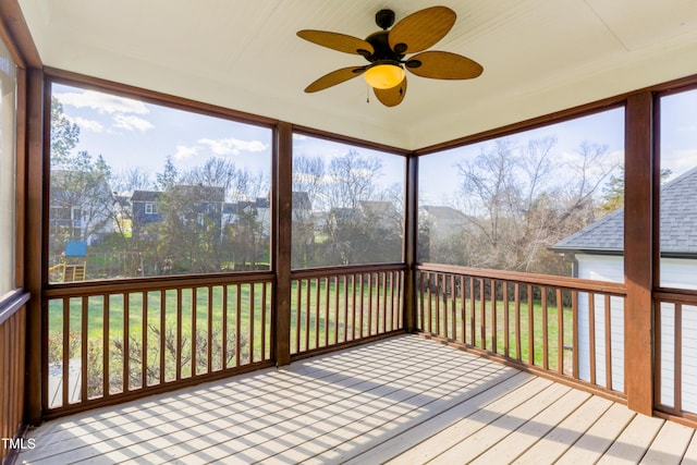 unfurnished sunroom featuring ceiling fan