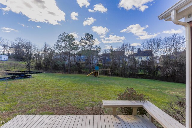 view of yard featuring a playground and a wooden deck