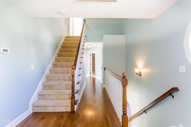 staircase featuring hardwood / wood-style flooring