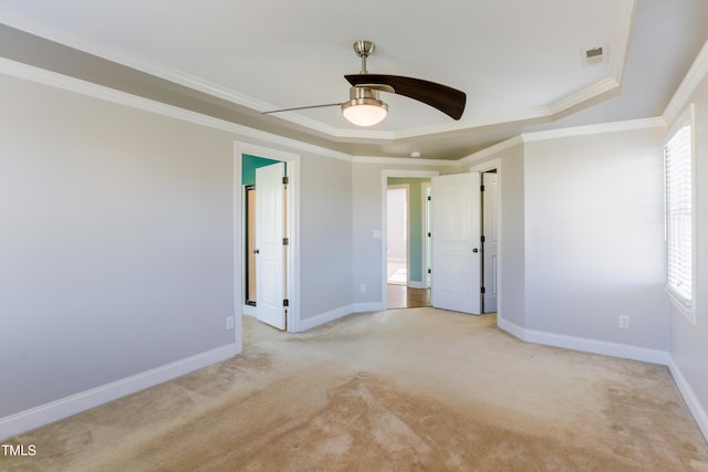 carpeted spare room with crown molding and ceiling fan