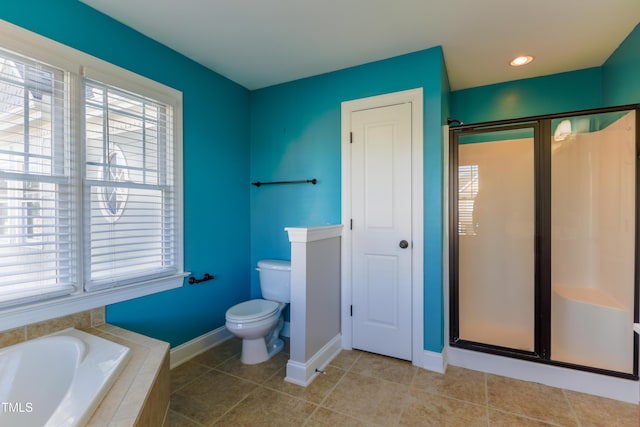 bathroom with tile patterned floors, toilet, and independent shower and bath