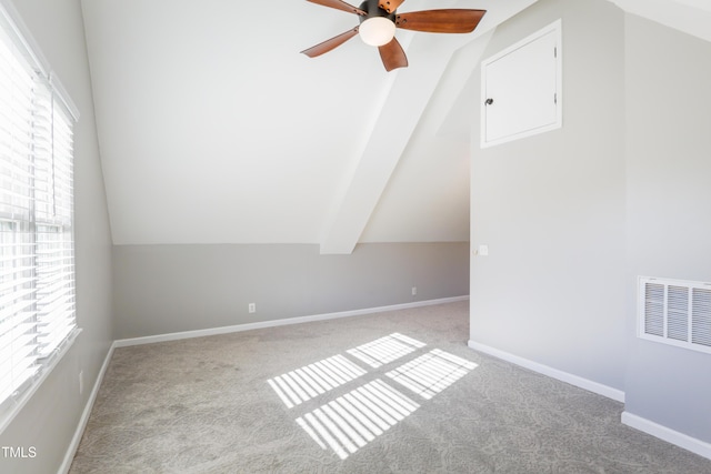 bonus room featuring vaulted ceiling, light colored carpet, and a wealth of natural light