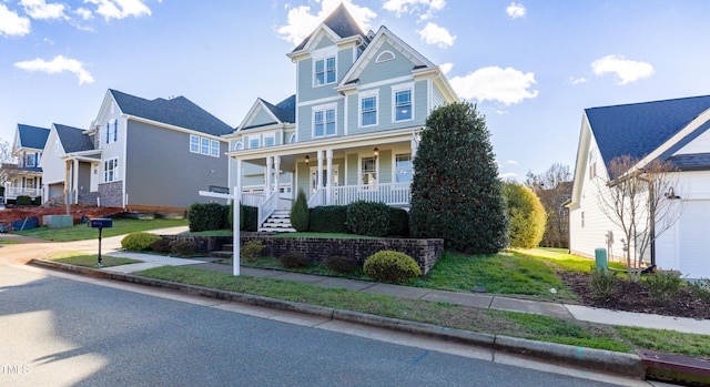 view of front of home with covered porch and a front lawn