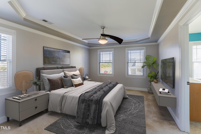 bedroom featuring crown molding, light colored carpet, ceiling fan, and a raised ceiling