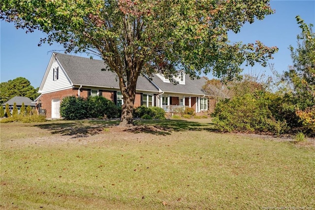 cape cod home with a front lawn, a garage, and brick siding