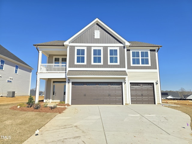 view of front facade with an attached garage, central AC, a shingled roof, driveway, and board and batten siding