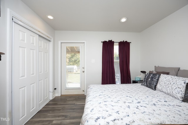 bedroom with access to exterior, a closet, and dark hardwood / wood-style flooring