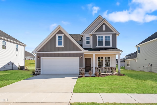 craftsman inspired home with concrete driveway, brick siding, board and batten siding, and a front yard