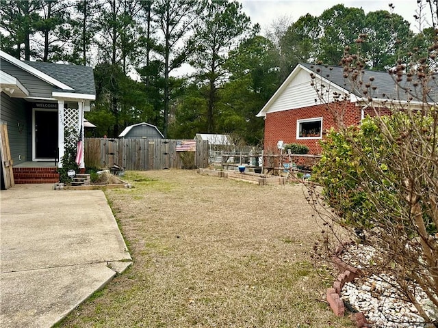 view of yard with fence and a gate