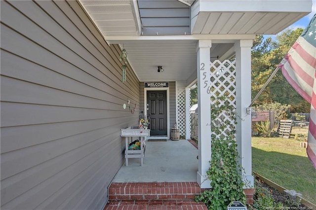 entrance to property with fence and a yard