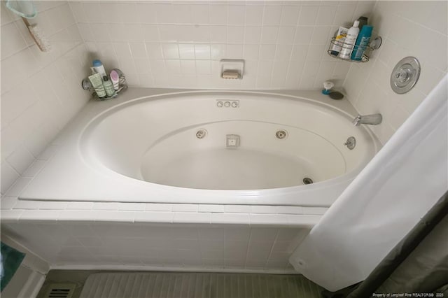 bathroom featuring a tub with jets