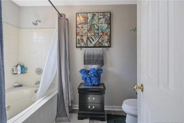 bathroom featuring shower / bath combo, toilet, and baseboards