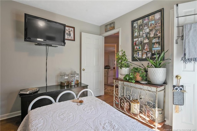 bedroom featuring dark wood-type flooring and baseboards