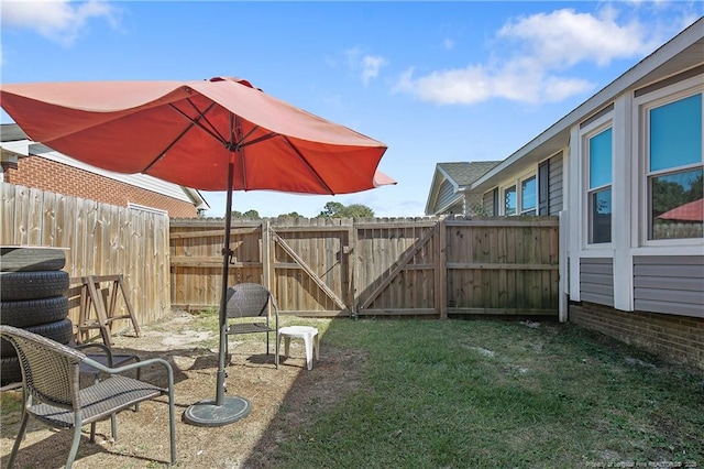 view of yard featuring fence and a gate