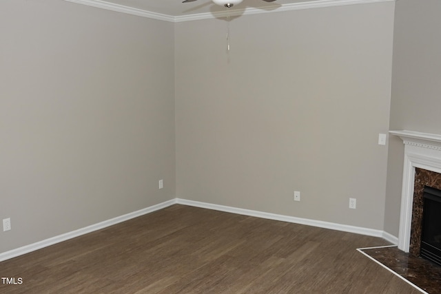 unfurnished living room featuring a high end fireplace, dark hardwood / wood-style flooring, ceiling fan, and ornamental molding