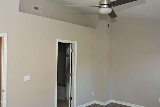 spare room featuring vaulted ceiling, ceiling fan, and dark hardwood / wood-style floors