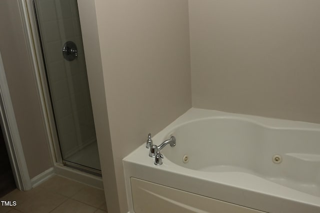 bathroom with tile patterned floors and independent shower and bath