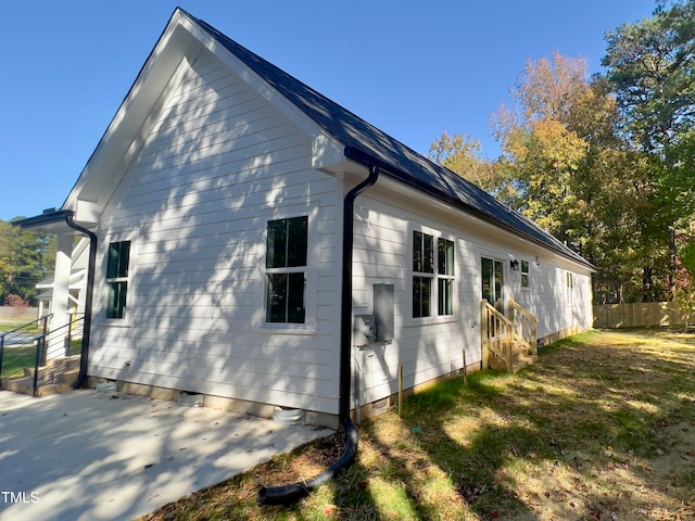 view of property exterior featuring a lawn