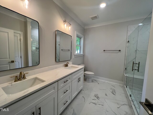 bathroom featuring a shower with door, ornamental molding, vanity, and toilet