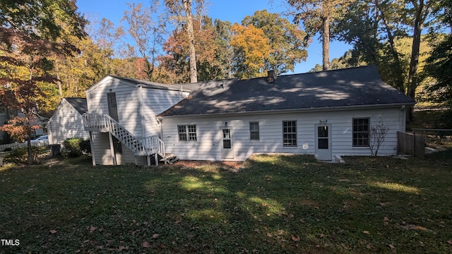 rear view of property with a yard