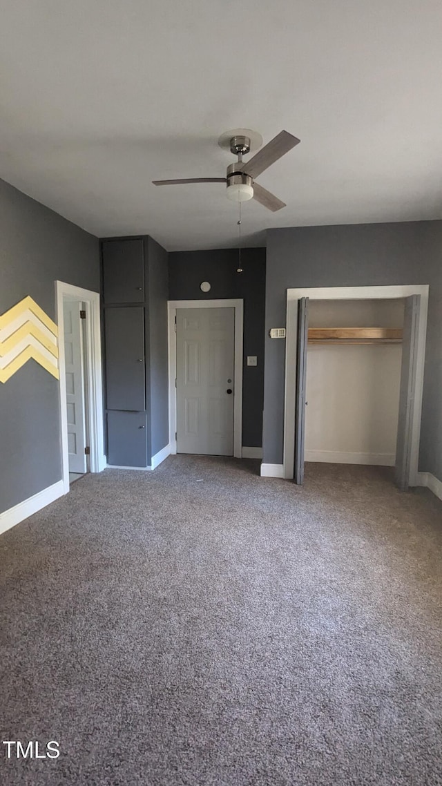 unfurnished bedroom featuring a closet, ceiling fan, and carpet floors