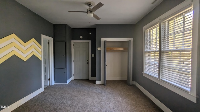 unfurnished bedroom featuring a closet, ceiling fan, and carpet flooring