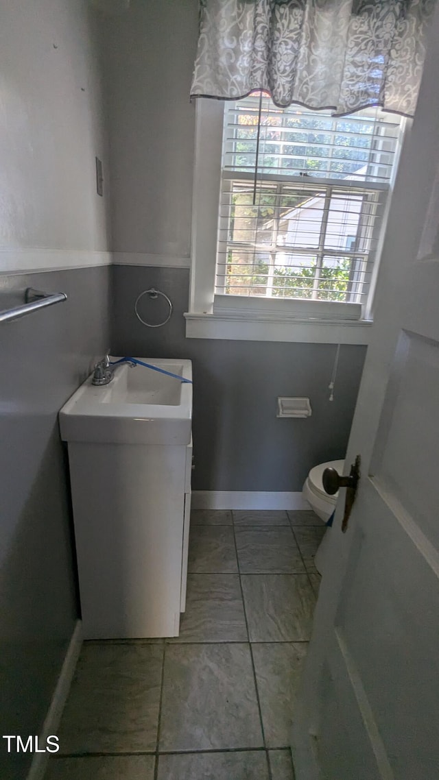 bathroom with vanity, toilet, and tile patterned flooring