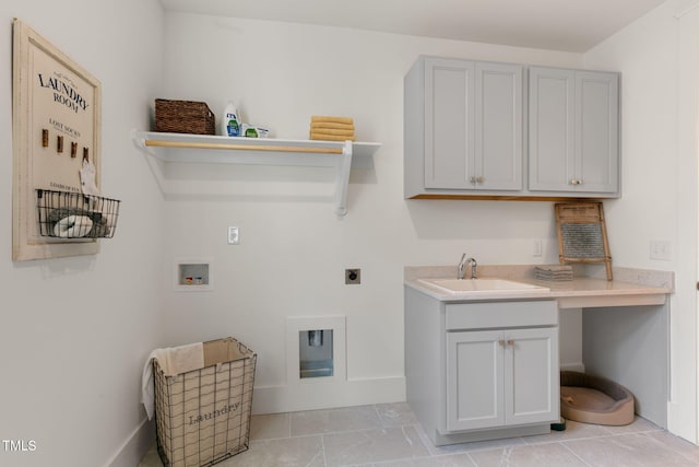 washroom with cabinets, light tile patterned floors, hookup for a washing machine, hookup for an electric dryer, and sink