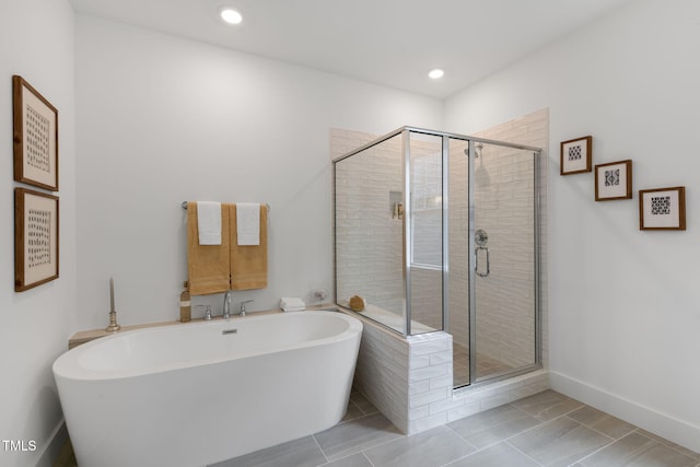 bathroom featuring independent shower and bath and tile patterned flooring