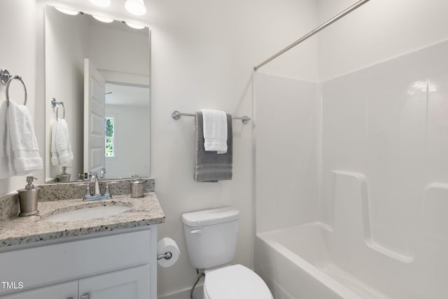 full bathroom featuring bathtub / shower combination, vanity, and toilet