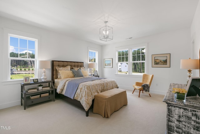 bedroom with an inviting chandelier and carpet floors