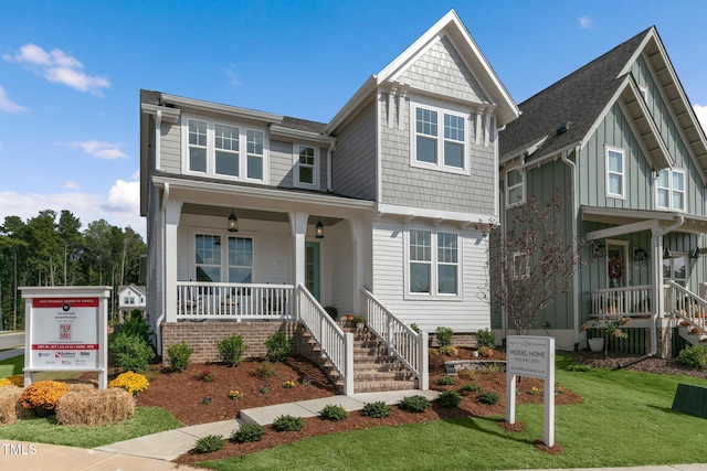 view of front of house with covered porch and a front lawn