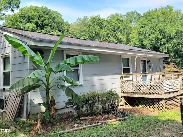 back of house with a wooden deck