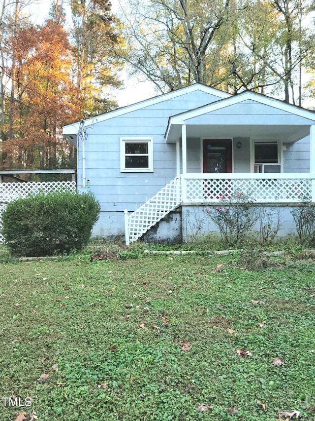 view of front of home featuring a front yard and covered porch