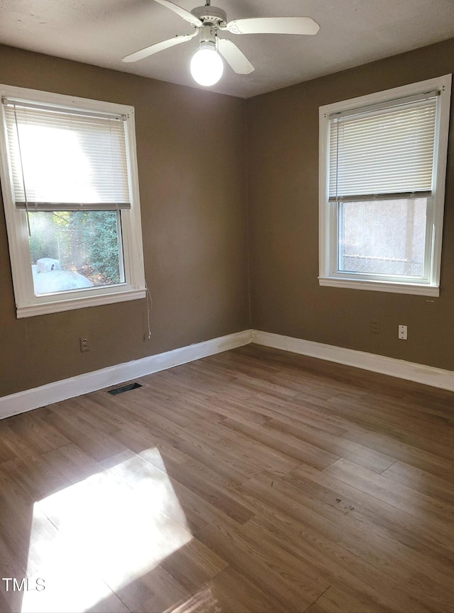 spare room with light hardwood / wood-style floors and ceiling fan