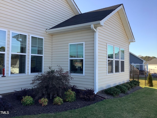 view of side of property with a lawn