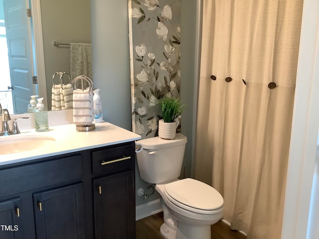 bathroom featuring toilet, walk in shower, hardwood / wood-style flooring, and vanity