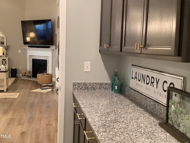 laundry room with light hardwood / wood-style floors