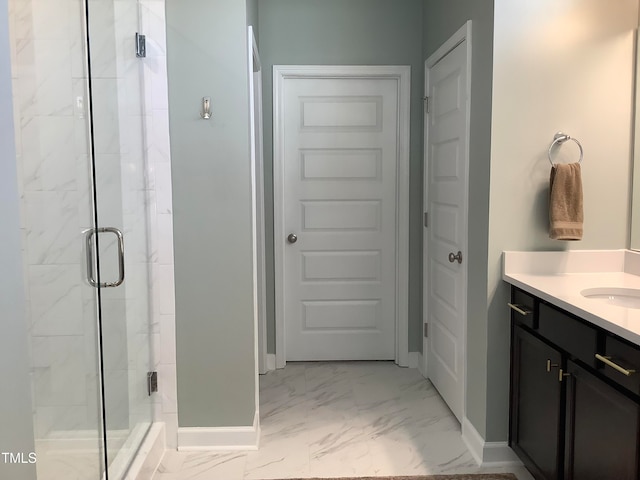 bathroom with vanity and a shower with shower door