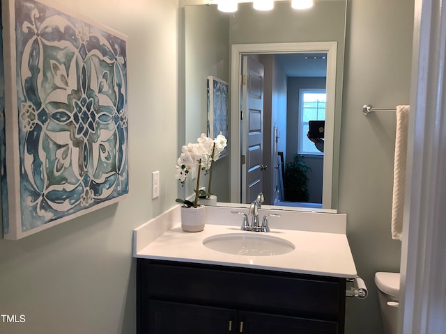 bathroom featuring toilet and vanity